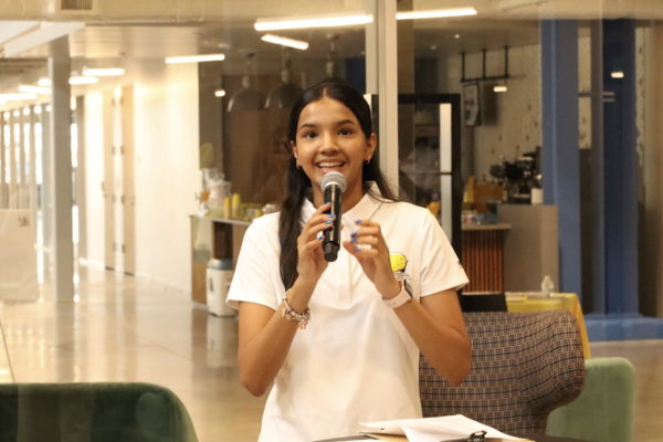 Photograph of Ishanvi (Ice) Venkatesh speaking at the EmpowerHer Summit, picture taken by Haasini Yatagiri